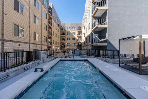 A small pool in a courtyard surrounded by buildings. at The Revival, Salt Lake City, 84101